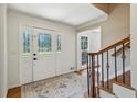 Cozy foyer with decorative glass door and a staircase to the upper floor at 3145 Indian Hills Ne Dr, Marietta, GA 30068
