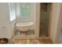 Elegant bathroom with a clawfoot tub, a separate glass-enclosed shower, and stylish fixtures at 4590 River Stone Trl, Douglasville, GA 30135