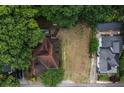 Aerial view of a home with a large, private yard surrounded by lush greenery and neighboring houses at 1052 Curran Nw St, Atlanta, GA 30318