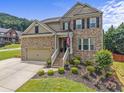 Charming two-story brick home featuring a manicured front yard and inviting entryway at 1850 Overlook Springs Ln, Cumming, GA 30040