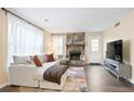 Bright living room featuring a stone fireplace, modern sofa, and ample natural light at 189 Timber Creek Ln, Marietta, GA 30060
