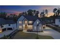 Elegant two-story home with modern architectural details and manicured front yard, showcasing sophisticated curb appeal at 2631 Sardis Way, Buford, GA 30519