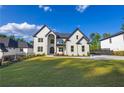 Charming two-story home with landscaped yard, complemented by a lush green lawn and inviting entryway on a sunny day at 2631 Sardis Way, Buford, GA 30519