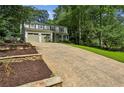 Traditional two-story home with a two-car garage, long driveway, and professionally landscaped front yard at 119 Laurel Mill Ct, Roswell, GA 30076