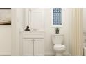 Bright white half-bath featuring modern sink, vanity, and decor, offering a clean and welcoming space at 2483 Cotton Ln, Douglasville, GA 30135