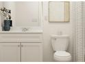 Bright half-bath features modern vanity, neutral patterned shower curtain, and stylish decor at 2483 Cotton Ln, Douglasville, GA 30135