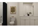 Modern half-bath features a dual sink vanity, sleek black shower curtain, and a large decorative mirror at 2483 Cotton Ln, Douglasville, GA 30135