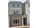 Newly constructed townhome featuring a brick facade and classic architectural design at 3336 Cranston Ln, Kennesaw, GA 30144