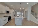 Modern kitchen boasts stainless steel appliances, a large island, and an open-concept layout at 3336 Cranston Ln, Kennesaw, GA 30144