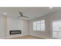 Bright living room with a ceiling fan, fireplace, and windows with pleasant natural light at 3336 Cranston Ln, Kennesaw, GA 30144