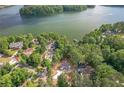 An aerial view of a luxury lakeside community with lush trees and beautiful waterfront homes at 912 Oak Dr, Woodstock, GA 30189