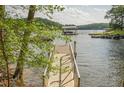 Beautiful waterfront property featuring a private dock with boat slip, offering stunning lake access at 912 Oak Dr, Woodstock, GA 30189