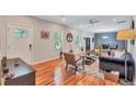 Open-concept living room with hardwood floors, modern furnishings, and lots of natural light at 2418 Bolling Brook Sw Dr, Atlanta, GA 30311