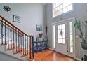 Bright foyer featuring hardwood floors, a staircase with rod iron spindles, and a high ceiling at 2420 Westport Cir, Marietta, GA 30064