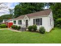 Charming home with fresh lawn and garden detail leading up to the front door at 429 Deckner Sw Ave, Atlanta, GA 30310