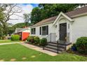 Charming house with landscaped front yard and inviting staircase leading to front door at 429 Deckner Sw Ave, Atlanta, GA 30310