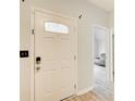Bright entryway showcasing modern door with decorative glass panel, and views into another room at 468 Berkshire Place, Fairburn, GA 30213
