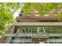 The MidCity Lofts building features a mix of brick, stone and glass with mature trees surrounding the property at 845 Spring Street Northwest Nw St # 307, Atlanta, GA 30308