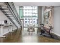 Spacious living room with high ceilings, large windows and metal staircase at 845 Spring Street Northwest Nw St # 307, Atlanta, GA 30308