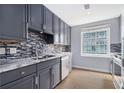Well-appointed kitchen featuring gray cabinets, stainless steel appliances, and a stylish mosaic backsplash at 195 14Th St # 902, Atlanta, GA 30309