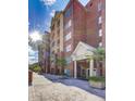 Exterior of condominium building featuring brick facade, windows, and a manicured landscape at 211 Colonial Homes Nw Dr # 2501, Atlanta, GA 30309
