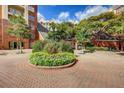 Exterior of condominium building with landscaped traffic circle and mature trees at 211 Colonial Homes Nw Dr # 2501, Atlanta, GA 30309