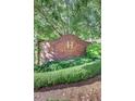 Condominium signage, featuring lush landscaping and brick architecture at 211 Colonial Homes Nw Dr # 2501, Atlanta, GA 30309