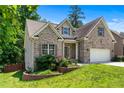Attractive brick home with a well-maintained lawn, two-car garage, and a charming landscaped garden at 350 Paces Dr, Lithia Springs, GA 30122