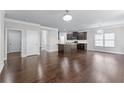 Spacious open-concept living area with hardwood floors, chandelier, and view into kitchen at 350 Paces Dr, Lithia Springs, GA 30122