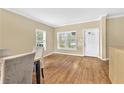 Welcoming entryway with hardwood floors, natural light from large windows, and a decorative front door at 827 Fraser Se St, Atlanta, GA 30315
