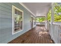 Spacious front porch with wood flooring and railing, offering a cozy outdoor space at 827 Fraser Se St, Atlanta, GA 30315