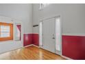 Bright entryway with hardwood floors and a white front door featuring sidelight curtains at 3524 Forest Downs Cv, Decatur, GA 30034