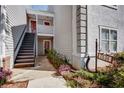 Close up of a two-story condo featuring stairs leading to the upper level entrance and a unit number sign at 72 Sutton Pl, Avondale Estates, GA 30002