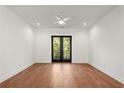Bright bedroom featuring hardwood floors and access to a private balcony with a view at 2325 Mason Dr # D22, Atlanta, GA 30316