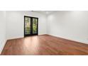 Spacious bedroom with hardwood floors and French doors leading to a private balcony at 2325 Mason Dr # D22, Atlanta, GA 30316