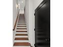 Bright staircase with wooden steps, white risers, and a modern handrail, leading to the upper level at 2325 Mason Dr # D22, Atlanta, GA 30316