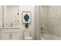 Stylish bathroom features modern tiling, updated vanity, and shower-tub combination at 255 Deer Valley Run, Canton, GA 30115