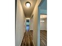 Inviting hallway with hardwood floors leading to a dining room with chandelier at 2832 Saratoga Lake Vw, Decatur, GA 30034