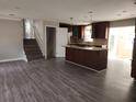 Open-concept kitchen with an island cooktop, stainless appliances, and hardwood floors at 3140 Kipling Dr, Powder Springs, GA 30127