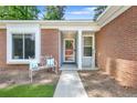 Inviting front porch with a cozy bench, decorative pillows, and a 'Welcome' sign at 1208 Brandl Sw Dr, Marietta, GA 30008