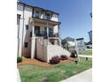 Inviting brick townhome with covered porch, professional landscaping, and for sale sign on a sunny day at 3564 Shore Wood Ave, Lawrenceville, GA 30044