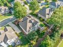 Aerial view of the home showcasing the backyard, deck, mature trees, and surrounding neighborhood at 4295 Cami Way, Buford, GA 30519