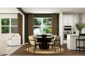 Stylish dining area with round table and chairs, adjacent to a bright, modern kitchen at 243 Deer Valley Run, Canton, GA 30115