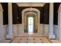 Elegant foyer with marble floors, soaring arches, and decorative columns creates a grand and welcoming entrance at 4790 Shallowford Rd, Roswell, GA 30075