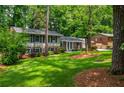 Two story traditional home featuring a well manicured lawn and mature landscaping at 6505 Whispering Ln, Atlanta, GA 30328