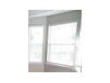 Bright bedroom featuring a large window that provides natural light at 1752 Spring Hill Cv, Lithonia, GA 30058