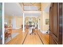 Bright foyer with soaring ceilings, hardwood floors, a view of the living room, and a staircase to the second floor at 2324 Littlebrooke Ln, Dunwoody, GA 30338