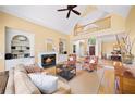Spacious living room with vaulted ceilings, a cozy fireplace, built-in bookcases, and a large window with backyard views at 2324 Littlebrooke Ln, Dunwoody, GA 30338