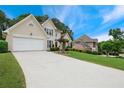 Beautiful home showcasing a long driveway and lush green lawn at 310 Medridge Dr, Alpharetta, GA 30022