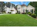 Lovely traditional-style home with manicured lawn and mature landscaping at 310 Medridge Dr, Alpharetta, GA 30022